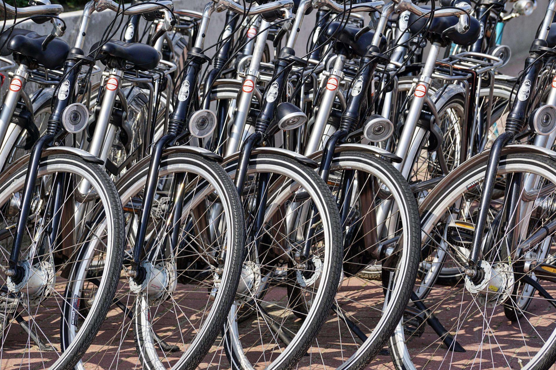 Gray and Black Bicycles Parked Near Gray Wall