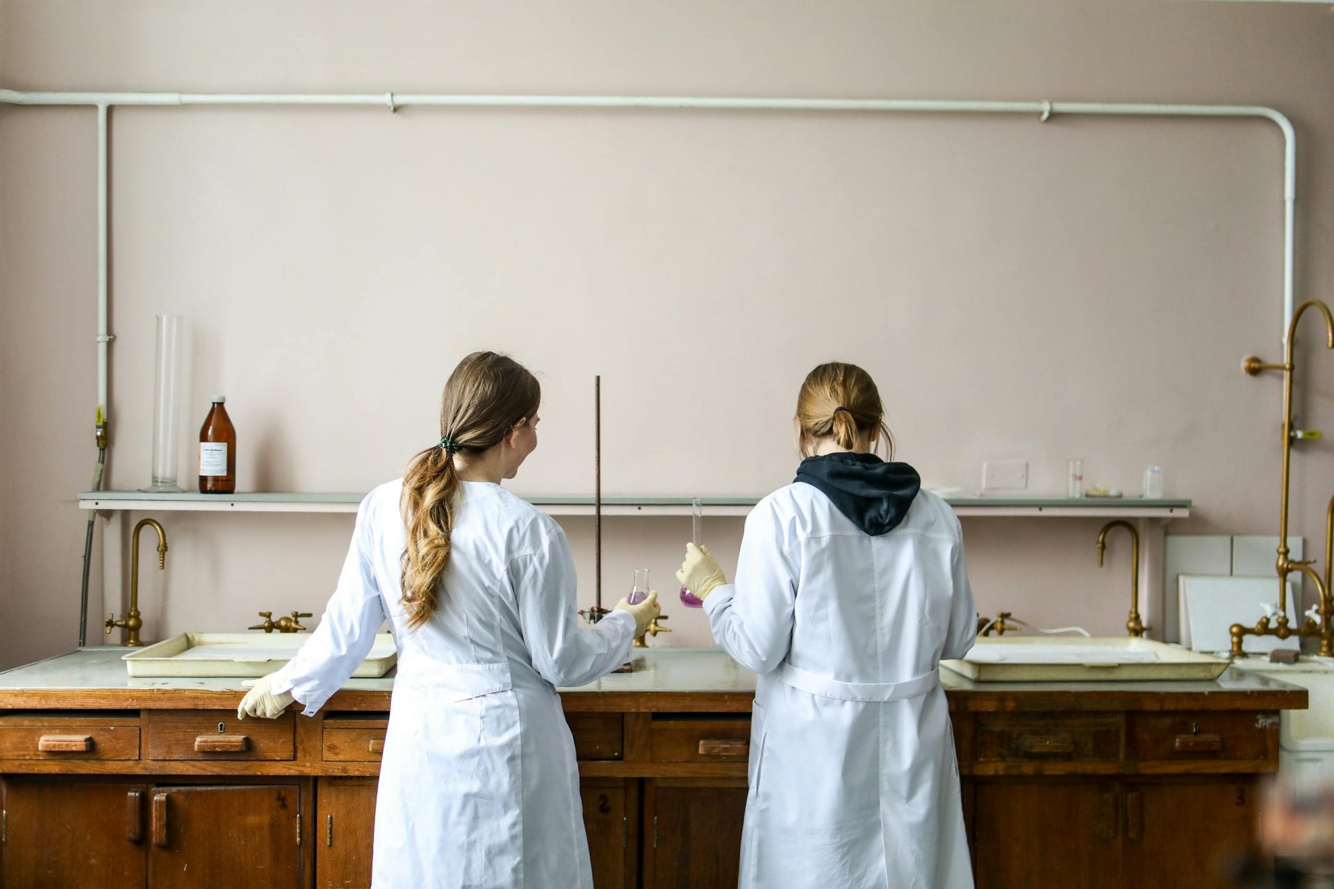 Two female scientists working on an experiment in a laboratory setting.
