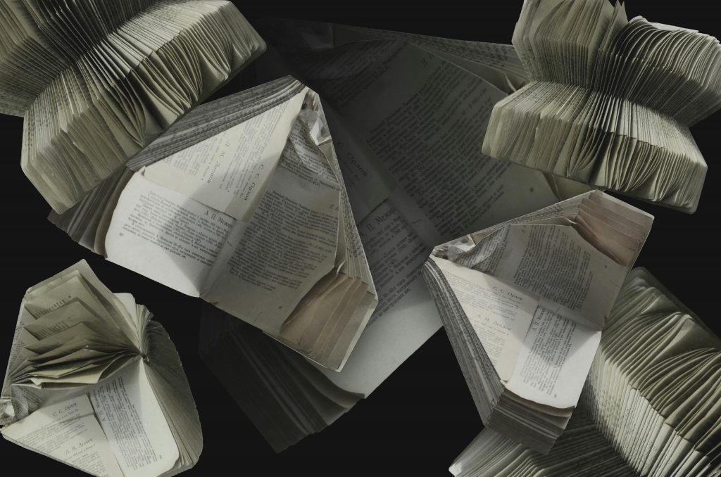 An abstract display of folded vintage books showcasing their pages and textures.