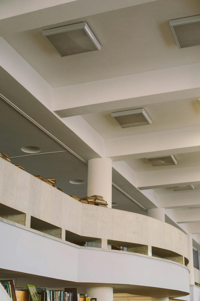 Curved bookshelves and modern architecture in an open, well-lit library interior.